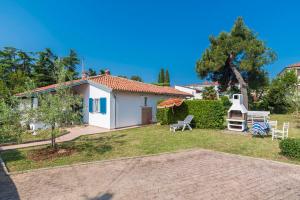 a villa with a garden and a house at House PUNTA UMAG in Umag