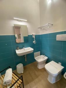 a bathroom with a toilet and a sink at B&B La mia Isola in Castelluzzo