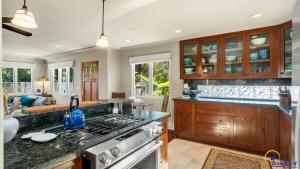 a kitchen with a stove top oven next to a living room at Ohana in Santa Cruz