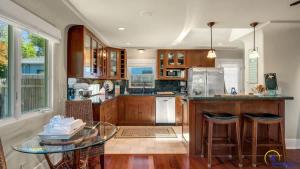 a kitchen with wooden cabinets and a glass table at Ohana in Santa Cruz