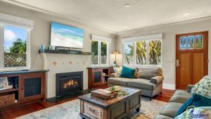 a living room with a couch and a fireplace at Ohana in Santa Cruz +21 photos