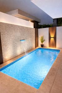 a swimming pool in the middle of a house at Modern Villa near Lisbon & Beaches with Heated Pool in Fernao Ferro
