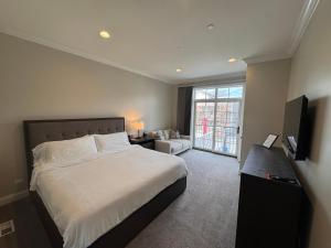 a bedroom with a large bed and a living room at The Sono Chicago in Chicago