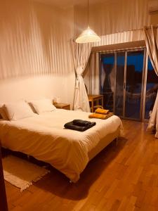 a bedroom with a bed and a large window at Ilhéu à Vista in Água de Alto