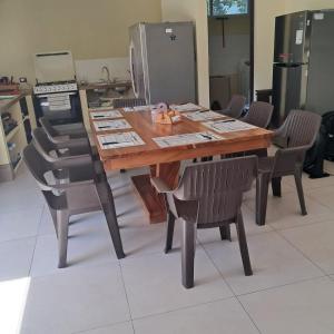 a wooden table with chairs and a printer at Casa La Yola in Monterrico