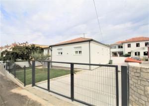a fence in front of a house at House Casa Fabris with Pool in Umag