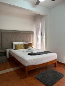 a bedroom with a large bed with a large headboard at CASARU HOTEL OAXACA in Oaxaca City +198 photos