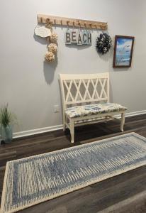 a bench sitting in a room with a rug at Sunset Beach townhome close to everything in Ocean Isle Beach