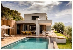 a villa with a swimming pool and a house at Casa Lilia in Olmeto