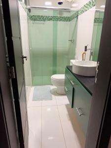 a bathroom with a toilet and a sink at CASA AMPLA e MODERNA com Suíte in Porto Velho +19 photos