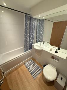 a bathroom with a toilet and a sink and a tub at Thistle & Tide in Edinburgh +52 photos
