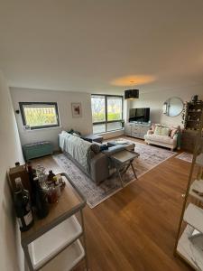 a living room with a couch and a table at Thistle & Tide in Edinburgh