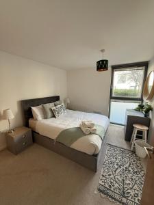 a bedroom with a large bed and a window at Thistle & Tide in Edinburgh
