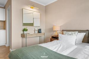 a bedroom with a bed and a mirror at Ferienwohnung Margaritha List auf Sylt in List