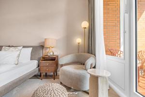 a bedroom with a bed and a chair and a table at Ferienwohnung Margaritha List auf Sylt in List