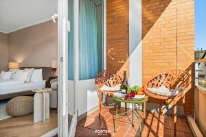 a room with a balcony with a bed and a table at Ferienwohnung Margaritha List auf Sylt in List +10 photos
