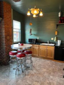 a kitchen with a table and stools in it at Desperado - CA King Size Bed - Sleeps 2-4 in Lynchburg