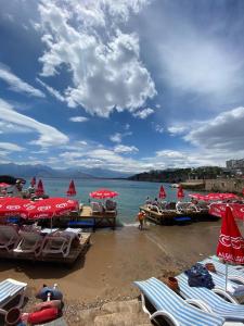 a group of umbrellas and chairs on a beach at Marina Hostel Pansiyon in Antalya