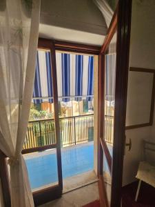 a window with a view of a balcony with a pool at Daniela House in Maiori