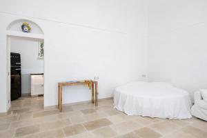 a white room with a bed and a table at Pane Amore e Magia in Anacapri +25 photos