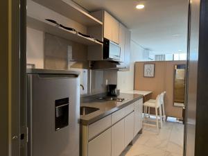 a kitchen with a refrigerator and a counter top at Purísima 5 0 in Monterrey