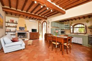 a living room with a table and chairs and a kitchen at Da Maria - Happy Rentals in Murlo
