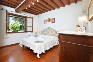 a bedroom with a bed and a table and a window at Da Maria - Happy Rentals in Murlo