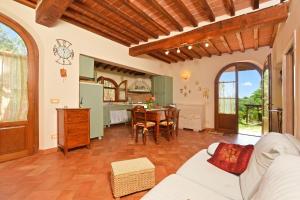 a living room with a white couch and a table at Da Maria - Happy Rentals in Murlo