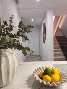 a bowl of lemons and limes on a table at Casa Benicasim in Benicàssim