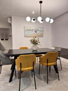 a dining room with a black table and chairs at Casa Benicasim in Benicàssim +18 photos