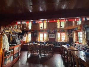 a room with tables and chairs in a restaurant at Hotel Mountain View - Namche in Namche +19 photos