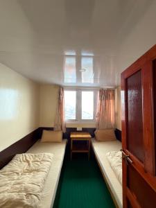 a small room with two beds and a window at Hotel Mountain View - Namche in Namche