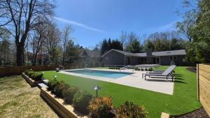 a backyard with a swimming pool and a house at Hidden Haven in Union Pier