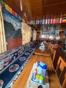 a dining room with tables and chairs in a train at Hotel Mountain View - Namche in Namche