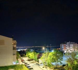 a city street at night with a bridge in the background at Blue Horizon SKG in Thessaloniki +20 photos