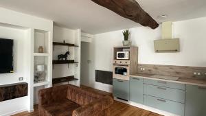 a living room with a couch and a microwave at Escapade au cœur du Haras in Le Mesnil-Rouxelin