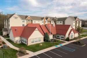 a building with red roofs in a parking lot at Residence Inn Columbia in Columbia
