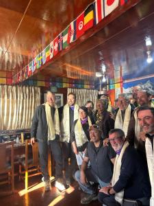 a group of people posing for a picture in a room at Hotel Mountain View - Namche in Namche