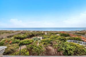 a view of the ocean from the balcony of a house at Azohva by Oak Island Accommodations in Caswell Beach