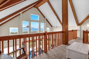 a view from the loft of a home with large windows at Azohva by Oak Island Accommodations in Caswell Beach +76 photos
