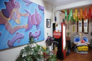 a room with a coca cola machine and a clown at CASARU HOTEL OAXACA in Oaxaca City