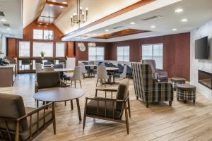 a restaurant with tables and chairs and a fireplace at Residence Inn Columbia in Columbia