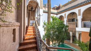 a stairway leading up to a building with a pool at Riad Maison Palmier in Marrakesh
