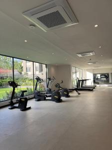a gym with a row of treadmills and exercise bikes at Delali Residence at The Bantree 5 mins from Airport in Accra