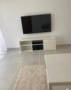 a living room with a flat screen tv at Samana condo by the beach in Las Terrenas