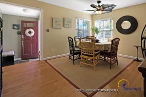 a dining room with a table and chairs and a red door at Beach Lovers Retreat in Santa Cruz