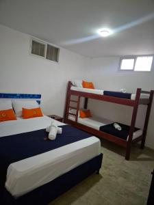 two beds in a room with two bunk beds at Hotel Girasol in Santa Rosa de Cabal