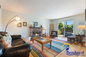 a living room with a couch and a fireplace at Mitchell's Cove Beach House in Santa Cruz