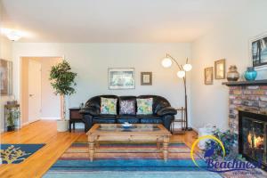 a living room with a couch and a fireplace at Mitchell's Cove Beach House in Santa Cruz