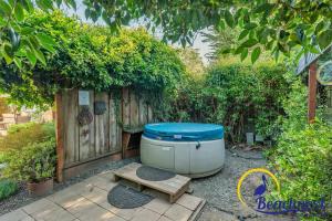 a bath tub sitting next to a wooden fence at Mitchell's Cove Beach House in Santa Cruz